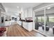 Modern kitchen with stainless steel appliances, black countertops, and scenic sunroom at 9053 Clydesdale Rd, Castle Rock, CO 80108