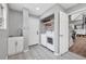 Laundry room with a sink, modern washer and dryer, and storage shelving at 9053 Clydesdale Rd, Castle Rock, CO 80108