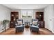 Cozy sitting area featuring chairs, wood bookshelves, and a window with picturesque views at 9053 Clydesdale Rd, Castle Rock, CO 80108
