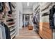 Large walk-in closet with custom shelving for optimal storage of clothes and shoes at 9053 Clydesdale Rd, Castle Rock, CO 80108