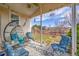 Cozy covered patio with comfortable seating, string lights, and a beautiful backyard view at 13124 Ivy Pl, Thornton, CO 80602