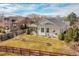 Expansive backyard with a well-manicured lawn, charming brick-lined flowerbeds, and a cozy covered patio at 13124 Ivy Pl, Thornton, CO 80602