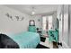 Bright bedroom featuring modern decor, a comfortable bed with stylish floral wall decorations at 13124 Ivy Pl, Thornton, CO 80602