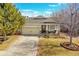 Charming home with a two-car garage, inviting front porch, and manicured lawn at 13124 Ivy Pl, Thornton, CO 80602