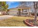 Inviting home featuring a manicured lawn, a two-car garage, and a charming front porch at 13124 Ivy Pl, Thornton, CO 80602