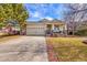 Charming single-Gathering home featuring a two-car garage and a cozy front porch with stone accents at 13124 Ivy Pl, Thornton, CO 80602