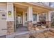 Cozy front porch featuring stone columns and comfortable seating, perfect for relaxing outdoors at 13124 Ivy Pl, Thornton, CO 80602