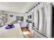 Bright kitchen featuring white cabinets, an island, and modern appliances, creating a functional space at 13124 Ivy Pl, Thornton, CO 80602