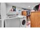 Functional laundry room with modern washer and dryer, plus ample storage space at 13124 Ivy Pl, Thornton, CO 80602