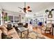 Open living space with hardwood floors connecting to the kitchen, with stylish accents and plenty of natural light at 13124 Ivy Pl, Thornton, CO 80602