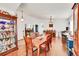 Spacious dining area featuring hardwood floors, ample seating, and stylish decor at 13124 Ivy Pl, Thornton, CO 80602