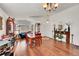 Bright and open living room with hardwood floors, a dining area, and plenty of natural light at 13124 Ivy Pl, Thornton, CO 80602