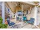 Cozy covered patio with comfortable seating, decorative items, and string lights at 13124 Ivy Pl, Thornton, CO 80602