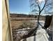 Scenic view of the landscape across a fence from a snowy patio, seen from inside the unit at 1652 S Idalia Cir # C, Aurora, CO 80017