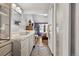 Bathroom with white sink, gray cabinets, and view of bedroom at 961 S Evanston Cir, Aurora, CO 80012