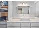 Modern bathroom with white sink, white cabinets, and tiled shower at 961 S Evanston Cir, Aurora, CO 80012