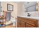 Bathroom with floral wallpaper and wood vanity at 961 S Evanston Cir, Aurora, CO 80012