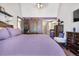 Main bedroom with king bed, barn door, and ensuite bathroom at 961 S Evanston Cir, Aurora, CO 80012