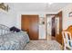 Spacious bedroom with wood closet doors and carpet at 961 S Evanston Cir, Aurora, CO 80012