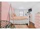 Charming bedroom with a queen bed and pink color scheme at 961 S Evanston Cir, Aurora, CO 80012