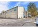 Rear exterior view of townhouse with garage and parking at 961 S Evanston Cir, Aurora, CO 80012