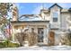 Charming two-story townhome with snow-covered landscaping at 961 S Evanston Cir, Aurora, CO 80012