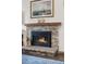 Gas fireplace with stone surround and wooden mantel at 961 S Evanston Cir, Aurora, CO 80012