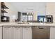 Modern kitchen with gray cabinets, white countertops, and stainless steel appliances at 961 S Evanston Cir, Aurora, CO 80012