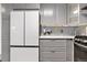 Modern kitchen with gray cabinets and white appliances at 961 S Evanston Cir, Aurora, CO 80012