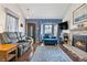 Living room with blue accent wall, fireplace, and hardwood floors at 961 S Evanston Cir, Aurora, CO 80012