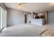 Inviting open-concept living room with plush carpeting and easy access to the kitchen at 15700 E Jamison Dr # 2-204, Englewood, CO 80112