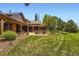 Expansive backyard featuring a patio with outdoor seating and a well-manicured lawn at 8576 Niwot Meadow Farm Rd, Niwot, CO 80503