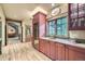 Charming bar area with wine fridge, sink, and custom cabinetry at 8576 Niwot Meadow Farm Rd, Niwot, CO 80503