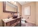 Rustic bathroom featuring a vessel sink and ornate wood vanity at 8576 Niwot Meadow Farm Rd, Niwot, CO 80503