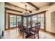 Elegant dining room with wood floors, exposed beams, and access to outdoor patio at 8576 Niwot Meadow Farm Rd, Niwot, CO 80503
