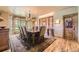 Cozy dining room with wooden floors, a chandelier, and a large window at 8576 Niwot Meadow Farm Rd, Niwot, CO 80503