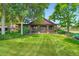 Charming home featuring a lush green lawn, covered porch, and mature shade trees at 8576 Niwot Meadow Farm Rd, Niwot, CO 80503