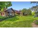 Charming stone home with lush landscaping and a well-manicured lawn at 8576 Niwot Meadow Farm Rd, Niwot, CO 80503
