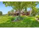 Beautiful home with a lush green lawn, mature trees, and professional landscaping at 8576 Niwot Meadow Farm Rd, Niwot, CO 80503