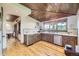 Charming kitchen featuring wood cabinets, tile countertops, and hardwood floors that offers a warm, inviting space at 8576 Niwot Meadow Farm Rd, Niwot, CO 80503