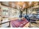 Inviting living room with a stone fireplace and wood accents at 8576 Niwot Meadow Farm Rd, Niwot, CO 80503