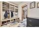 Well-organized mudroom with built-in storage, shelving, hooks, slate flooring, and convenient access to the home at 8576 Niwot Meadow Farm Rd, Niwot, CO 80503