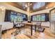 Bright office with wood-paneled ceiling, large windows, and hardwood floors at 8576 Niwot Meadow Farm Rd, Niwot, CO 80503