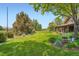 Well-maintained yard showing off the lush green lawn, beautiful gardens and mature trees at 8576 Niwot Meadow Farm Rd, Niwot, CO 80503