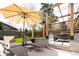 Outdoor living featuring a shaded patio with lounge chairs, grilling area, and well-manicured lawn at 175 S Jasmine St, Denver, CO 80224