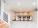 Basement bar area, complete with stools and stylish pendant lighting at 175 S Jasmine St, Denver, CO 80224