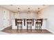 Finished basement with bar, featuring granite counter and stylish barstools at 175 S Jasmine St, Denver, CO 80224