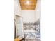 Bathroom featuring wood ceiling, tub with stone surround and large mirror at 175 S Jasmine St, Denver, CO 80224