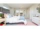 Inviting bedroom with cozy bedding, eclectic decor, and ample natural light at 175 S Jasmine St, Denver, CO 80224