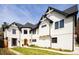 Stunning two-story home features a white exterior, black trim, and a meticulously maintained front yard at 175 S Jasmine St, Denver, CO 80224